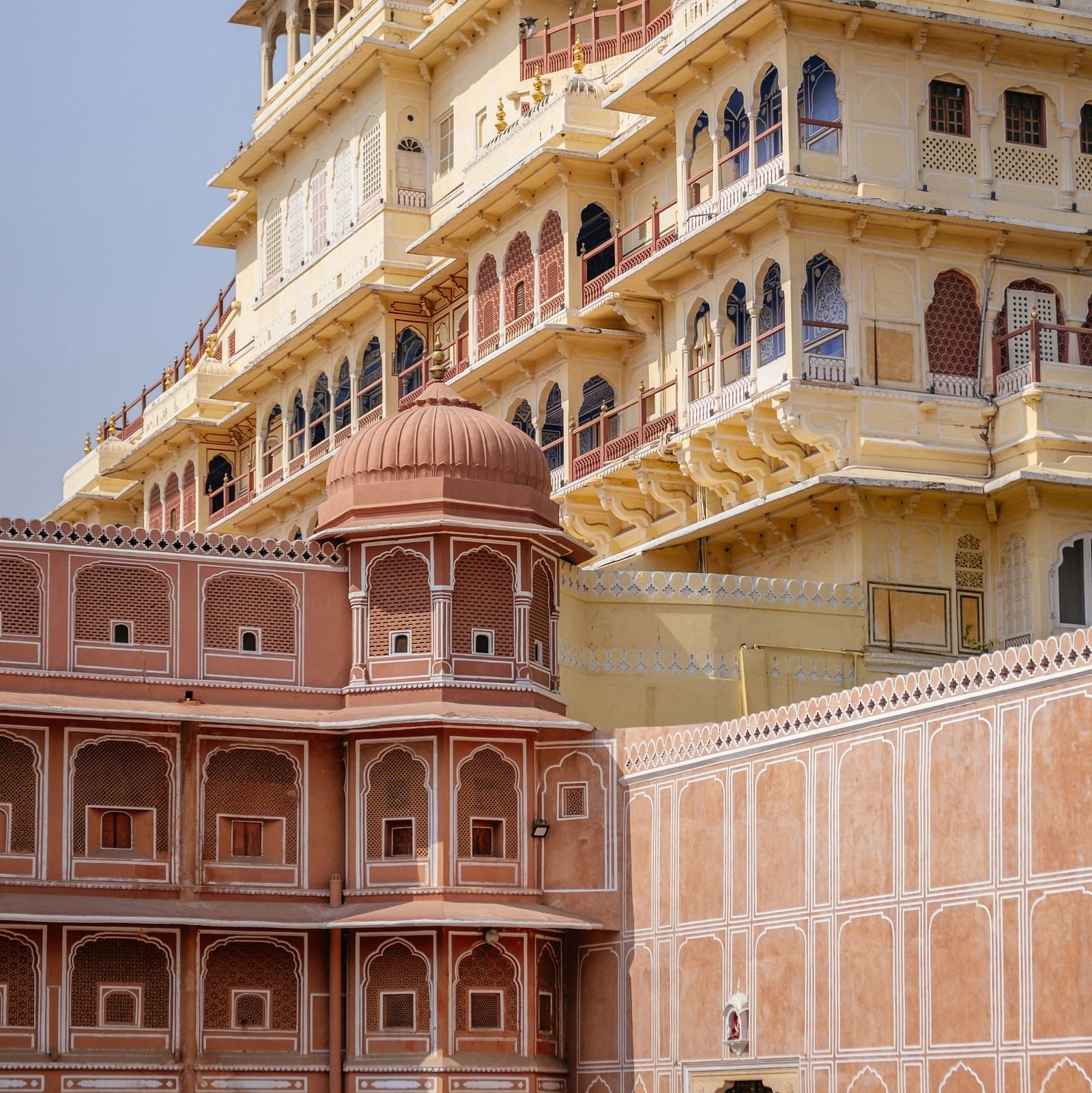 Red-stoned buildings against a clear sky.